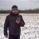 Man in Shabby Winter Jacket Having an Online Video Chat Standing in a Rural Field in Winter - VideoHive Item for Sale