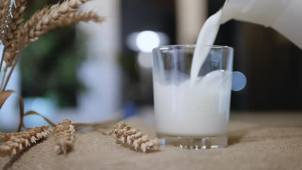 Slow Motion Glass With Fresh Milk On Bokeh Background. A Rustic Style Natural Dairy Product
