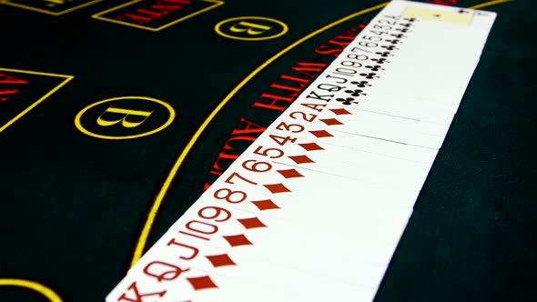 Playing Cards Are Spread Out on Green Surface Poker Table