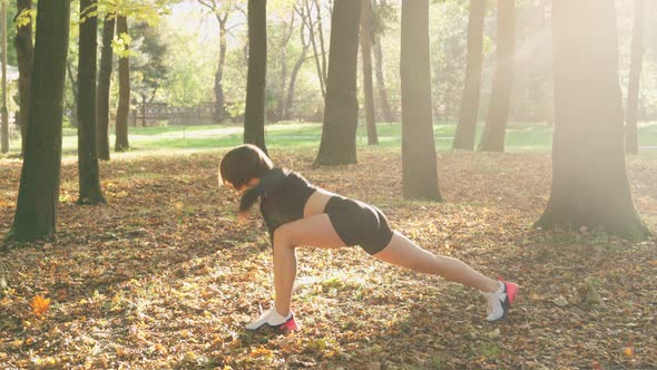 Female Athlete Flexing Legs While Training at Park