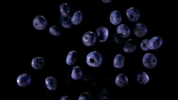 Top View of Ripe Blueberries Bouncing and Rotating on the Black Background