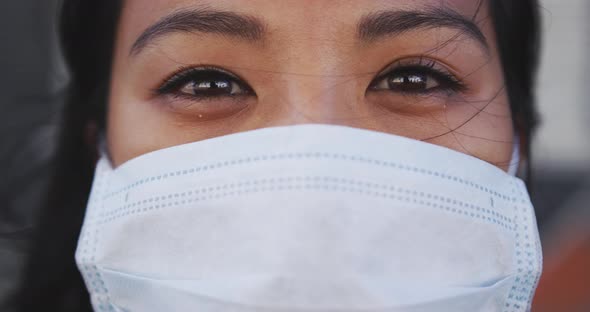 Woman wearing medical coronavirus mask looking at camera