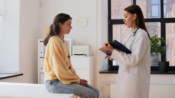 Doctor with Clipboard and Woman at Hospital