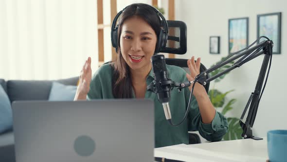 asia girl record a podcast with headphones and microphone look at camera  talk and take a rest.