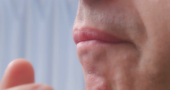 A Man Eats a Cherry Tomato Closeup