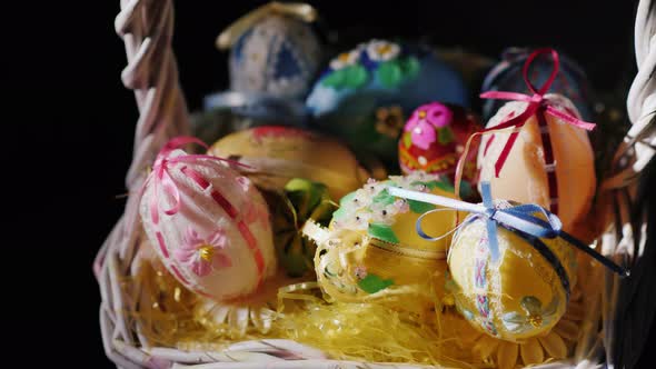 Basket with Easter Decorations on a Black Background