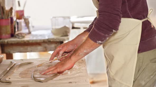 Male potter working on clay in pottery workshop