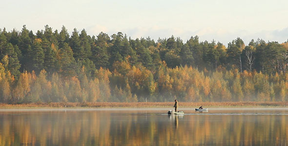 Fishermen On Lake And Autumn Trees