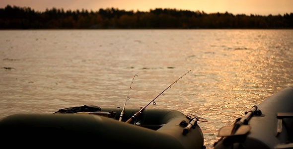 Fishing Rubber Boat With Rods At Sunset alt