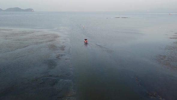 Fishing boat move at muddy stream