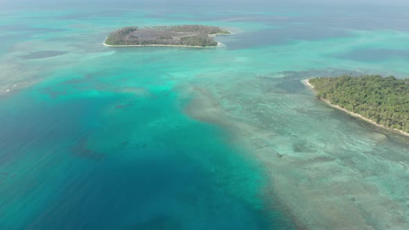 Aerial: flying over desert island tropical beach caribbean sea turquoise water c