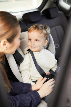 looking at mom ready for safe ride in family car
