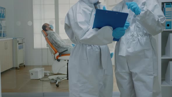 Professional Stomatologists Wearing Ppe Suits at Oral Clinic