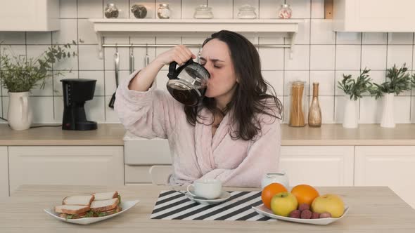 Woman Pours Coffee After Sleepless Night at Home