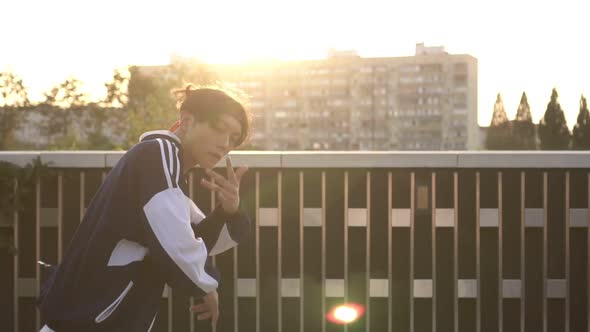 Young Man Dancing Hiphop and Break Dance on the Background of the Street Slow Motion