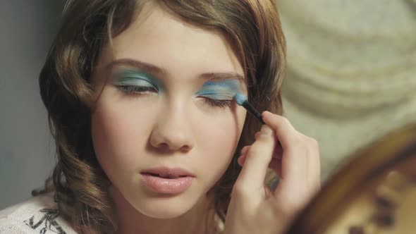 Young Schoolgirl Painting Her Eyes with Eye Shadow, First Makeup, Growing Up