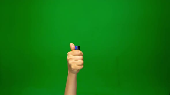 Hand Is Lighting and Extinguishing Lighter. Green Screen. Close Up.