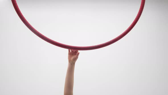 Blonde Girl In A Red Dress Hangs On An Aerial Hoop And Turns Around