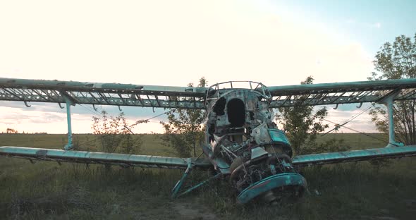 Close-up View of Disassembled Fuselage of Old Skeleton of USSR Maize Plane Standing in Thick Grass