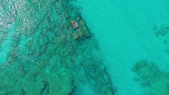 Birdseye Aerial Descend of Sunken Cargo Ship Barco Hundido at Bottom in Beautiful Clear Waters of Sa