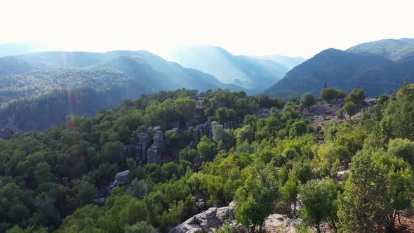 Aerial Panoramic View of Forested Mountains Slopes with Rock Formations