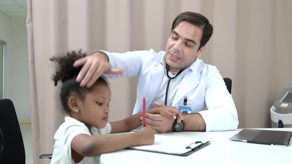 A doctor at an international hospital Trying to check up of a mischievous child in the hospital's OP