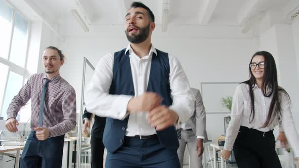 Slow Motion Portrait of Office Workers Male and Female Dancing Relaxing in Workplace