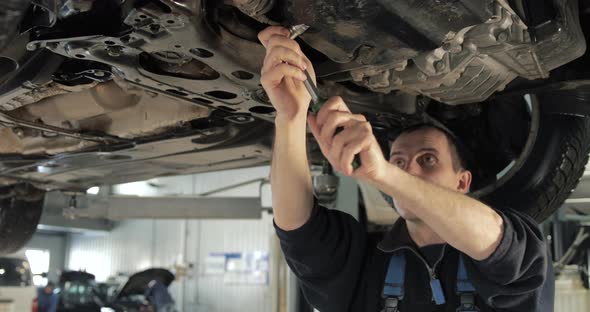 Car Service. Mechanic Removing The Oil Cap