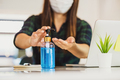 Closeup Asian woman hand using hand sanitizer when working at home with technology laptop - PhotoDune Item for Sale