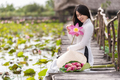 Portrait of beautiful vietnamese woman with traditional vietnam hat holding the pink lotus - PhotoDune Item for Sale