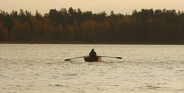 Rowing Fisherman On Wooden Boat