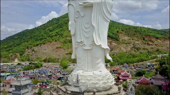 Drone Flies Closely To Buddha Statue Pedestal and Towers
