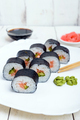 Traditional eastern dish with salmon sushi rolls on a white plate. Close-up. - PhotoDune Item for Sale