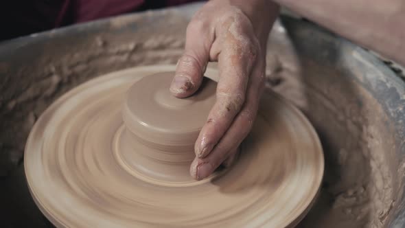 The Hands of a Potter Creating an Earthen Jar on the Circle Closeup Hands on Circle with Clay