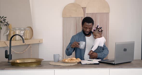 Young Family Using a Laptop During Breakfast