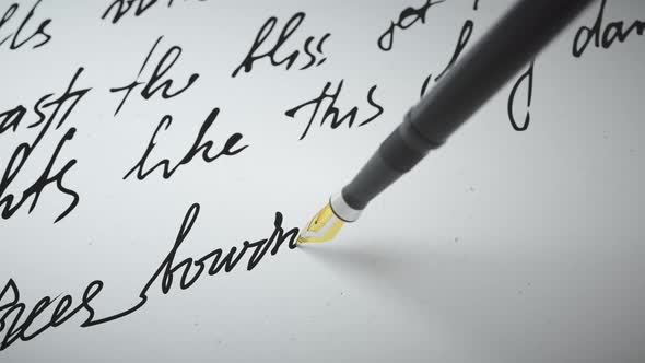 Ink Pen Writes Verse on Paper Close Up