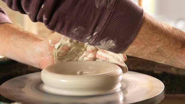 Male potter making pot