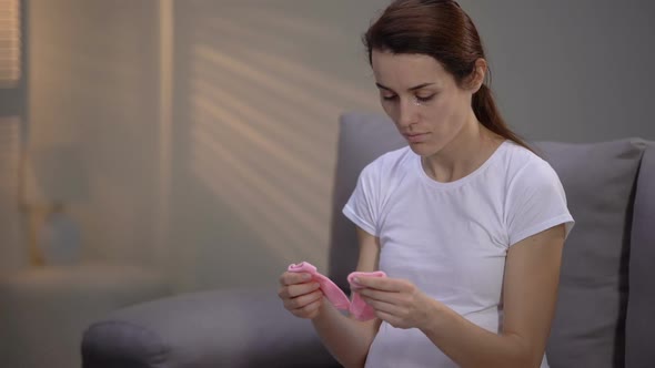 Crying Pregnant Woman Holding Pink Socks, Congenital Abnormality, Pregnancy Loss