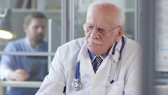 Senior Practitioner Talking to Female Patient