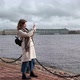 A Young Woman with a Mobile Phone in Her Hands Takes Pictures of the Embankment of the Neva River in - VideoHive Item for Sale