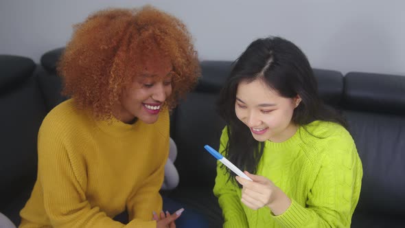 Happy Lesbian Couple with Positive Pregnancy Test. Family Planing Concept