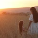 Beautiful mother and daughter together enjoy the sunset in countryside on a summer day - VideoHive Item for Sale