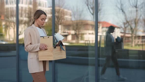 Woman Carrying Box with Office Stuff While Living Office