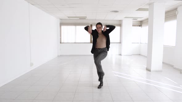 Happy Young Rental Estate Female Agent Dancing in a New Empty Office