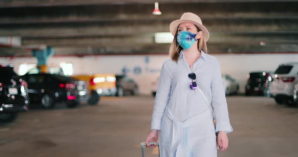 Safe Travels Under COVID-19 Stylish Traveler in Colorful Mask at Airport Parking