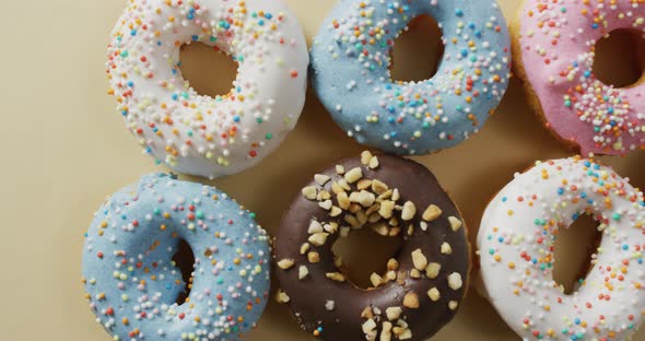 Video of donuts with icing on white background