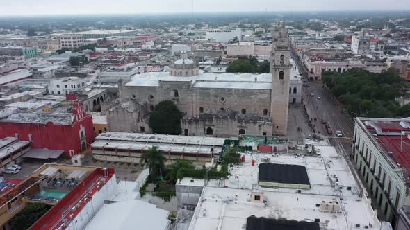 Pushing in on the Cathedral of Merida and the Grand Plaza from Hidalgo Park in Merida, Yucatan, Mexi
