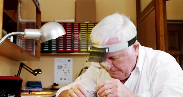 Horologist repairing a watch