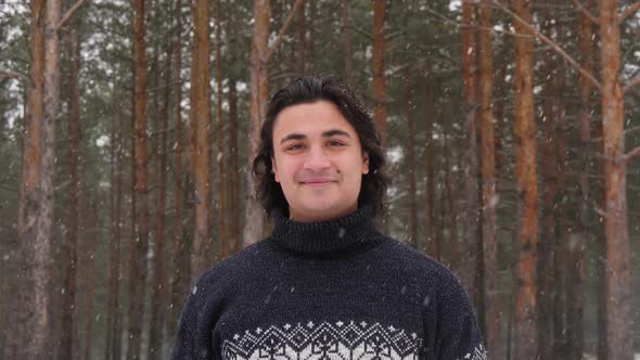 Mixed Race Latin Hispanic Man in Warm Sweater Looking at Camera and Smiling on Blurred Background