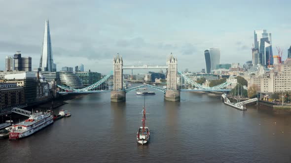 Aerial Daytime View to the Lifted Tower Bridge and Yacht Going Through It